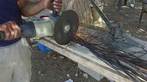 The worker works with the Angle Grinder Stock Footage 77290279