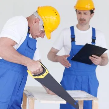 Worker works with handsaw Stock Photos