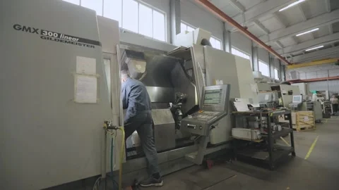 The worker works on a modern CNC machine. Modern workshop with CNC machines. A Video stock 203882761