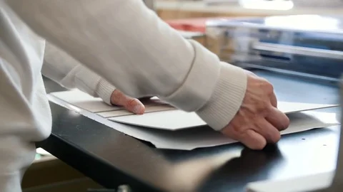 Worker works at polygraph machine, printing industry Stock Footage 76931051