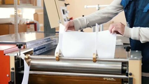 Worker works at polygraph machine, printing industry Stock Footage 77572697