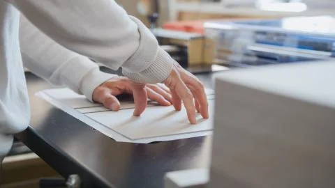 Worker works at polygraph machine, printing industry Stock Photos