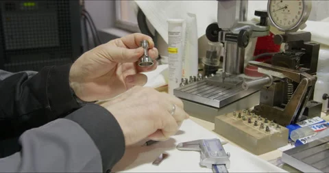 Worker works with precision measuring instruments at metalworking plant 動画素材 171571191