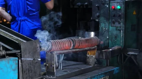 Worker works on a punching machine with electric heating of the workpieces. Stock Footage 49432290