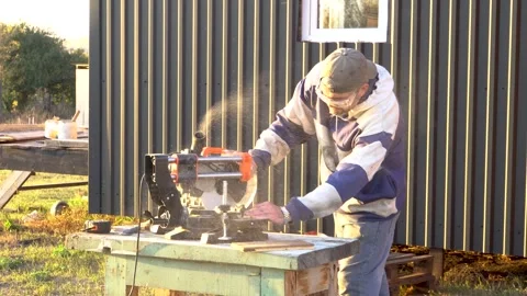 A worker works on a saw 4K Stock Footage 294047307
