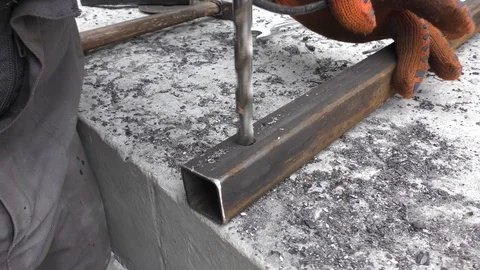 Worker in the workshop drills a hole in the metal with a hand drill. Stock Footage 116206815