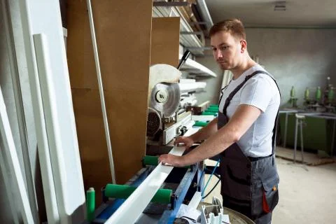 Worker in the workshop prepares pvc profiles Stock-Fotos