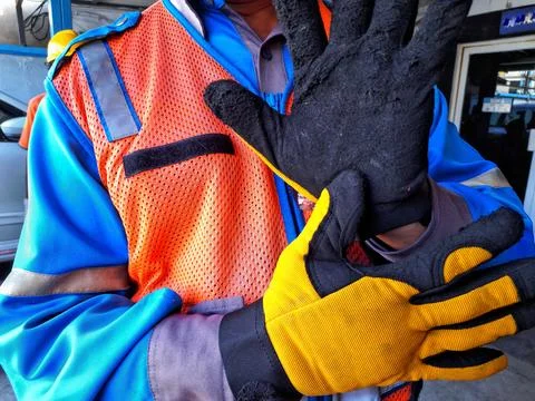 A worker with worn gloves on his hands Stock-Fotos