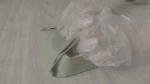 Worker wraps a square cheese in banana leaf, inside a factory in boyaca colombia Stock Footage 222015654
