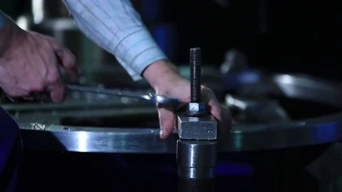Worker with a wrench tighten screws Stock Footage 76594965