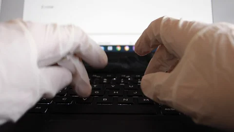 Worker writes on the computer using sterile white gloves Stock Footage 127683682