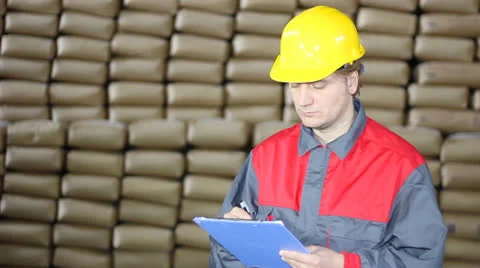 Worker writing on clipboard in Warehouse Stock Footage 27166943