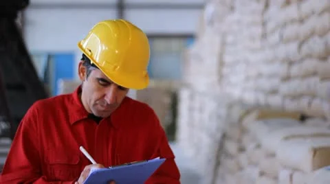 Worker writing results in Warehouse Stock Footage 9025876