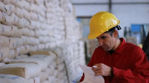 Worker writing results in Warehouse Stock Footage 9446396