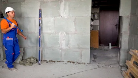Worker young man with a sledgehammer in his hand dancing and dancing, the end of Stock Footage 115438016