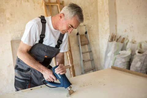 Workerr repairs the door in a carpenter's workshop Stock Photos