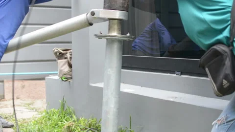 Workerr twists the screw piles foundation for building home Stock Footage 162057206