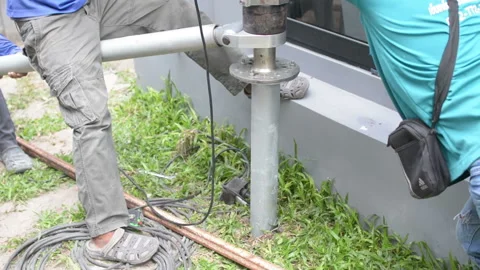 Workerr twists the screw piles foundation for building home Stock Footage 162057235
