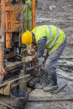 Workers add a length of pipe Stock Photos
