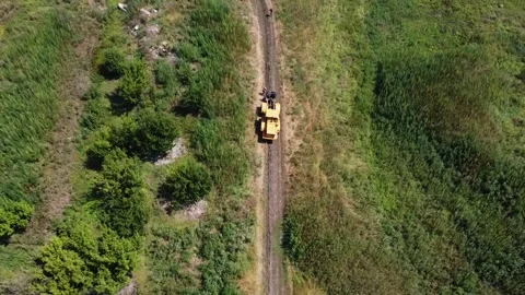 Workers adjusting rope to ensure proper placement under ground for communication Stock Footage 300852894