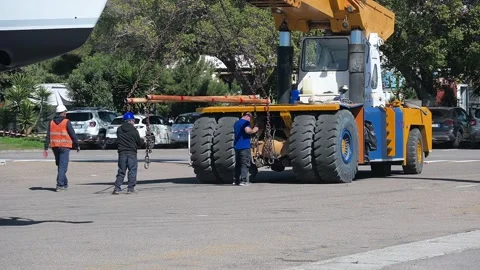Workers align heavy chains for lifting process in Cagliari, Sardinia Stock Footage 310252100