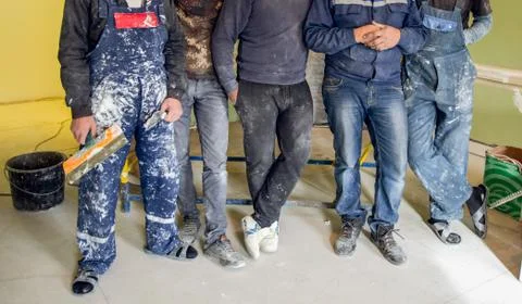 Workers and builders and foreman are as gang with dirty uniform are staying in Stock Photos