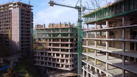 Workers and cranes on the building construction complex Stock Footage 168555759