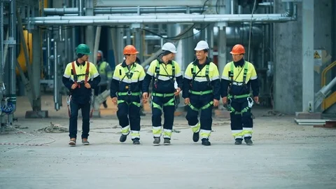 Workers and engineers walking on industrial factory Stock Footage