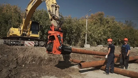 Workers and excavator on a construction site pile driving into the ground Stock Footage 71218664