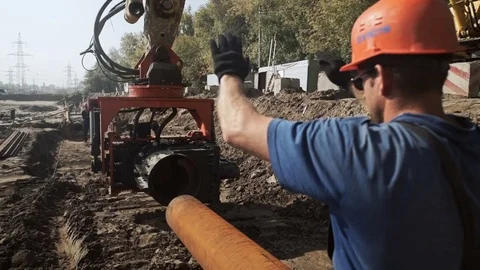 Workers and excavator on a construction site pile driving into the ground Stock Footage 71219232