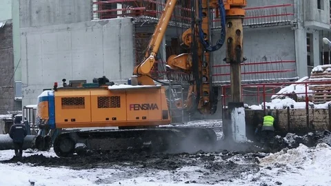 Workers and pile rig machine at construction site. 動画素材 71533344