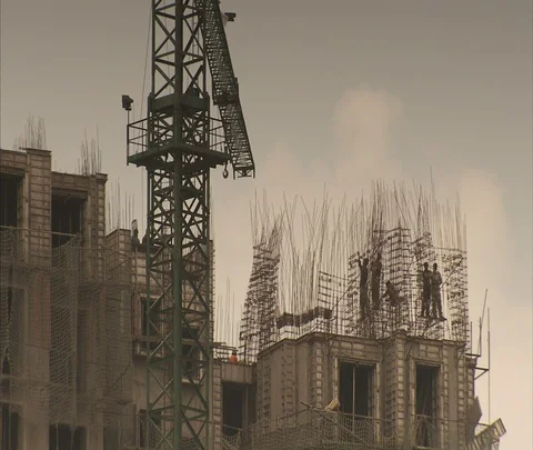 Workers and scaffolding atop new high-rise construction. Stock Footage 86742576