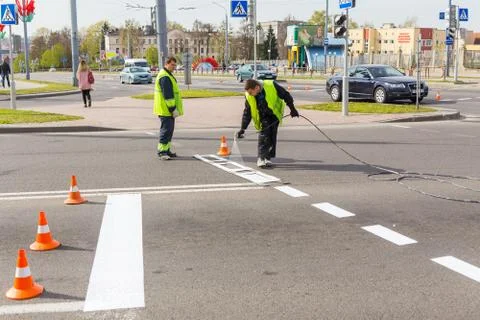 Workers applied road markings Stock Photos