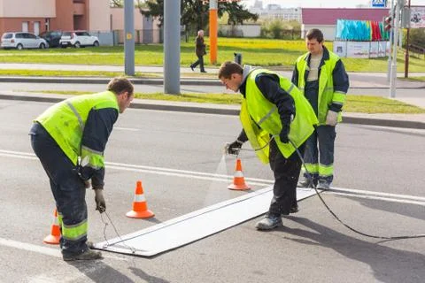 Workers applied road markings Фото