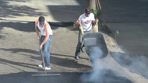 Workers apply asphalt hot top, road construction pavement Stock Footage 55019076