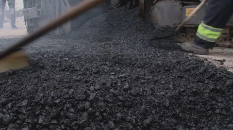 Workers apply asphalt to road. People filling the hole on the street. Stock Footage 64012302