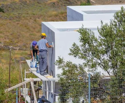 Workers Applying Decorative Facade Plaster . Stock Photos