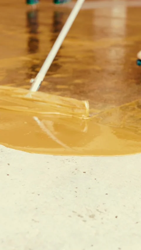 Workers applying epoxy resin flooring with quartz aggregate Stock Footage 316762775