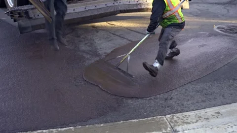 Workers applying slurry seal Stock Footage 241930231