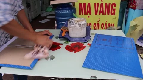 Workers are applying glue to the cover files.  Stock Footage 58627495
