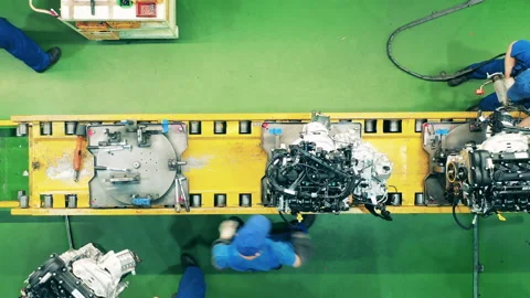 Workers are assembling car's inner parts in a top view Stock Footage 141524317