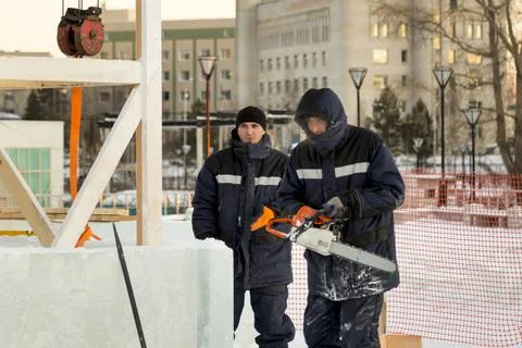 Workers are assembling ice blocks on the frame of a wooden slide 스톡 사진