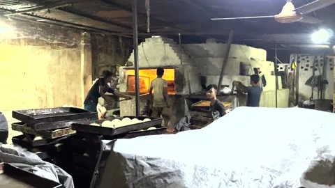 Workers are baking bread in a local bakare factory . Stock Footage 256708566