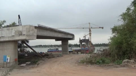 Workers are building a bridge across the river Stock Footage 328533148
