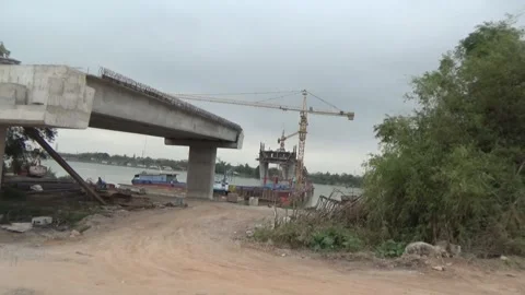 Workers are building a bridge across the river Stock Footage 328533270