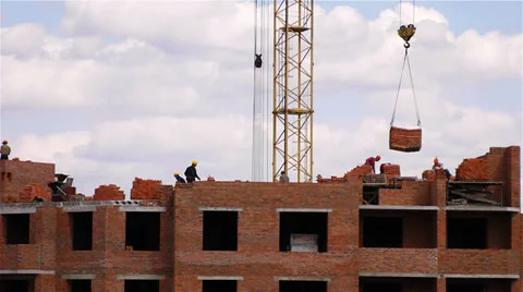 Workers are building a skycraper with a help of crane time lapse Stock Footage 25059818