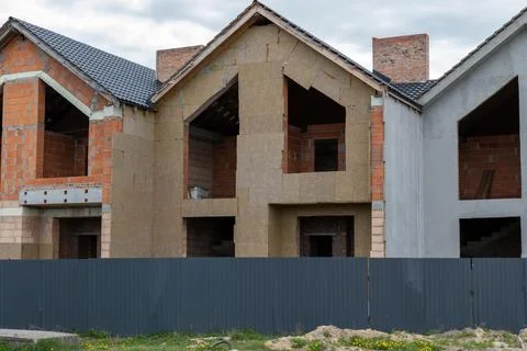 Workers are busy on a construction site where houses are being built with e.. Stock-Fotos