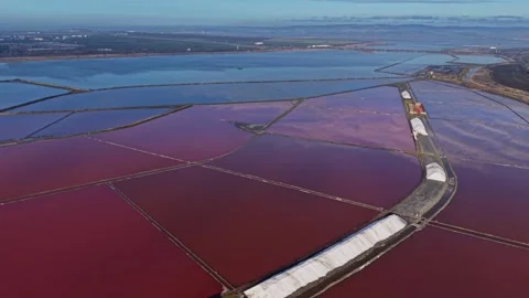 Workers are busy in a salt flat with rich colors from minerals Stock Footage 328527323