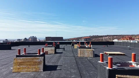 Workers are completing the installation of a rooftop on a building in a city Stock Footage 331331158