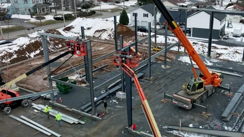 Workers are constructing a new building structure in a residential area. They Stock Footage 338059335